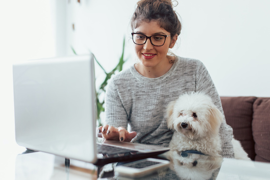 employee taking a zoom call with their pet dog